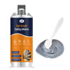 A bottle of high strength casting adhesive with a spatula applying the gray epoxy material.