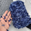 A close-up of a dark blue variegated yarn used for knitting and crochet