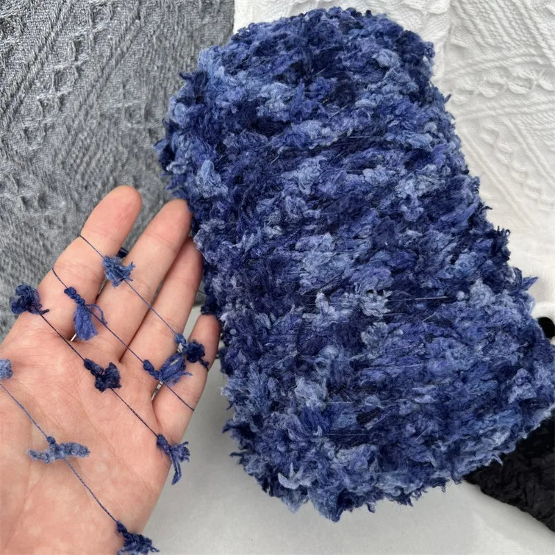 A close-up of a dark blue variegated yarn used for knitting and crochet