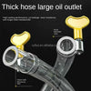 A close-up view of a thick hose large oil outlet with a brass fitting and clear flexible hose.