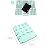 A set of light green plastic folding boards and a black organizer for folding clothes.
