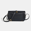 A black genuine leather square crossbody bag with a gold lock and strap.