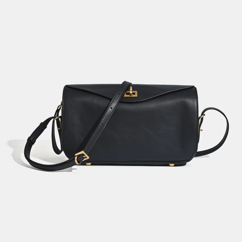A black genuine leather square crossbody bag with a gold lock and strap.