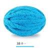 A ball of bright turquoise chenille yarn used for hand knitting projects.