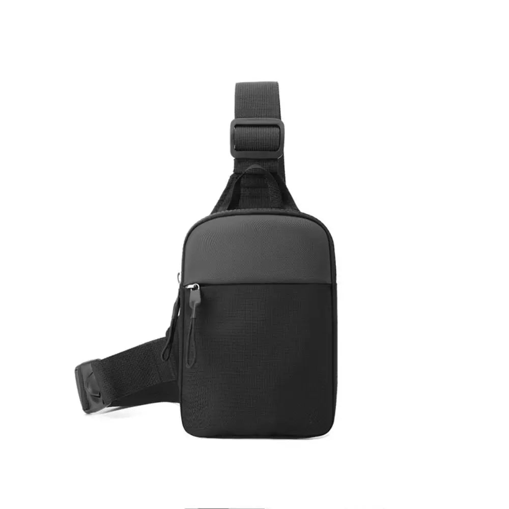 Black compact canvas crossbody sling bag with a strap shown from the back.