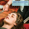 A woman is using a tuning fork set for sound healing, demonstrating deep relaxation.
