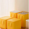 A bright yellow waterproof moving and storage bag with a foldable lid is shown next to a white window blind.