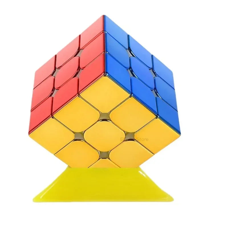A 3x3 magnetic speed cube with a mirror finish in red, blue, and yellow colors resting on a yellow base.