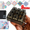 A hand holds a clear plastic keychain with multiple colored tactile clicking buttons and a metal keyring.