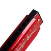 A red harmonica with a black cap and silver accents, showing the numbered holes.