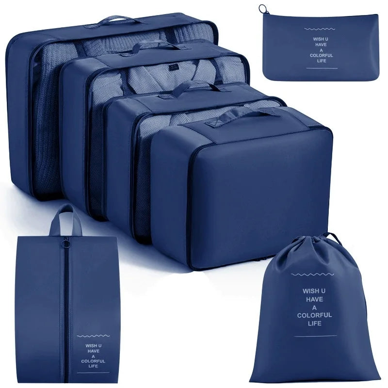 A set of navy blue travel packing cubes and storage organizer bags shown in various sizes.
