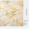 A close-up of a beige quilted fabric featuring delicate yellow and green botanical embroidery for bedding.