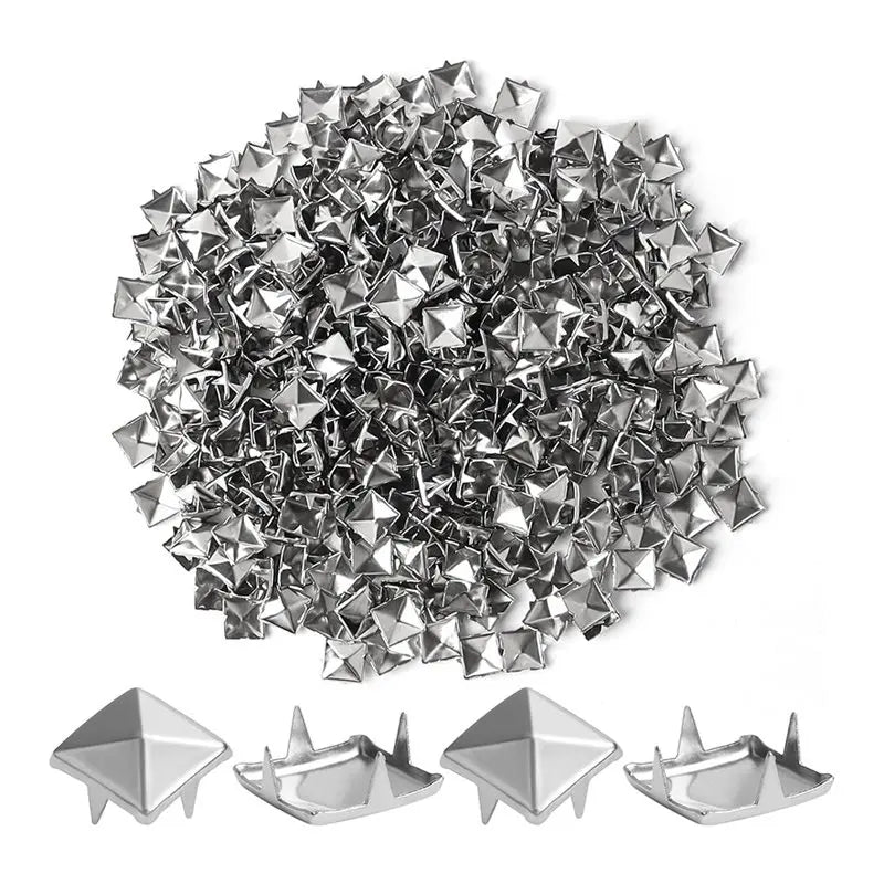 A pile of silver metal pyramid studs with four prongs for DIY fashion projects