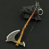 A detailed metal sword keychain featuring a stylized blade and handle, displayed against a dark background.