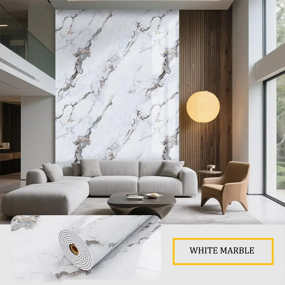 A modern living room featuring a sofa and coffee table against a white marble accent wall.