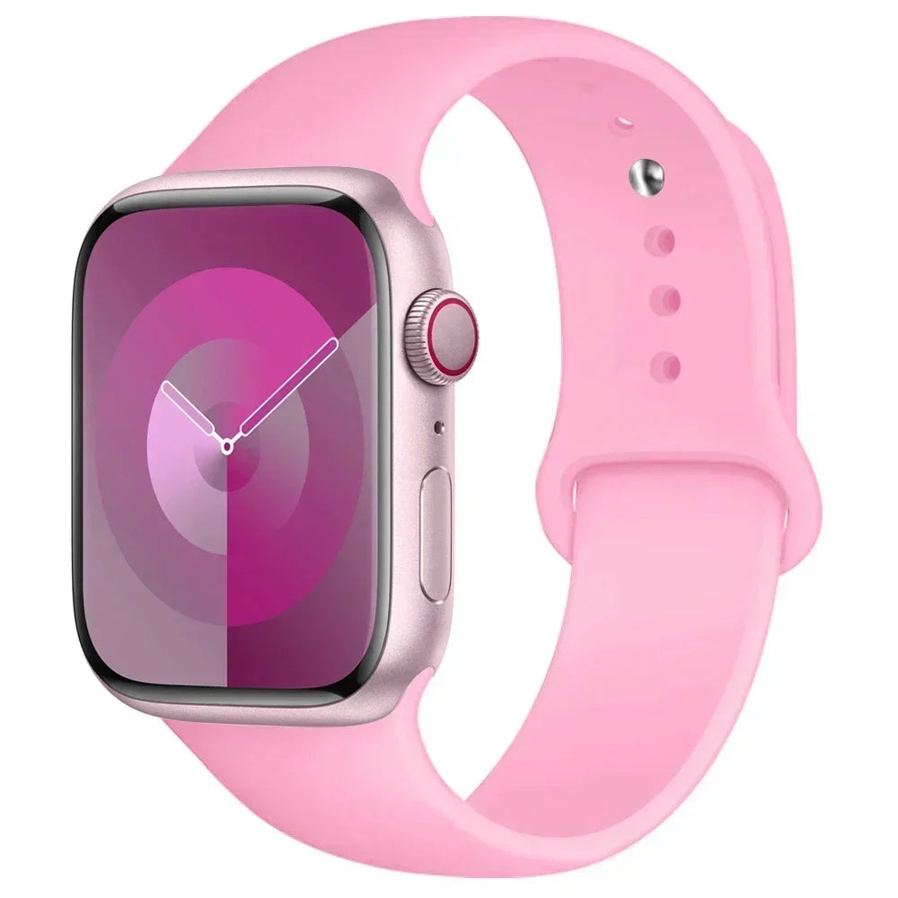 A pink silicone sport band worn around an Apple Watch.