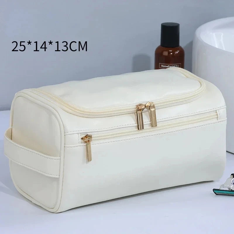 A cream-colored PU vintage luxury toiletry bag with a zippered compartment and gold-toned hardware.