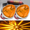 A pair of orange watermelon LED marker and turn signal lights mounted on a vehicle, showing bright light beams.