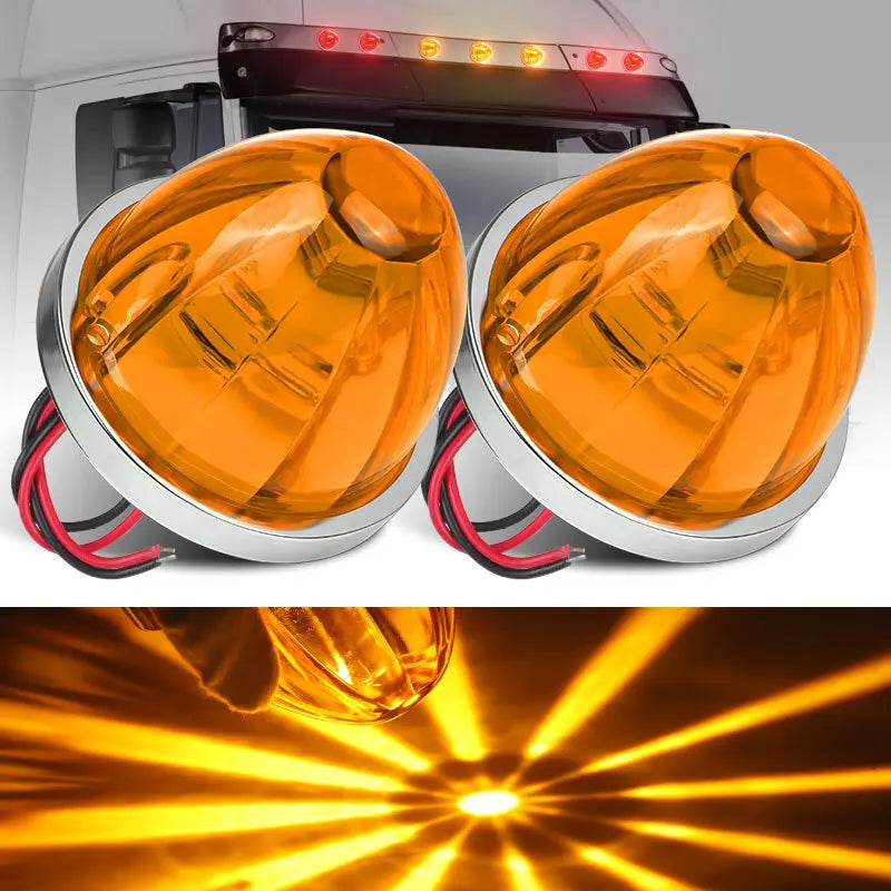 A pair of orange watermelon LED marker and turn signal lights mounted on a vehicle, showing bright light beams.