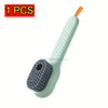 A light green reusable shoe laundry bag with a white handle and a grey bristled brush for gentle washing.