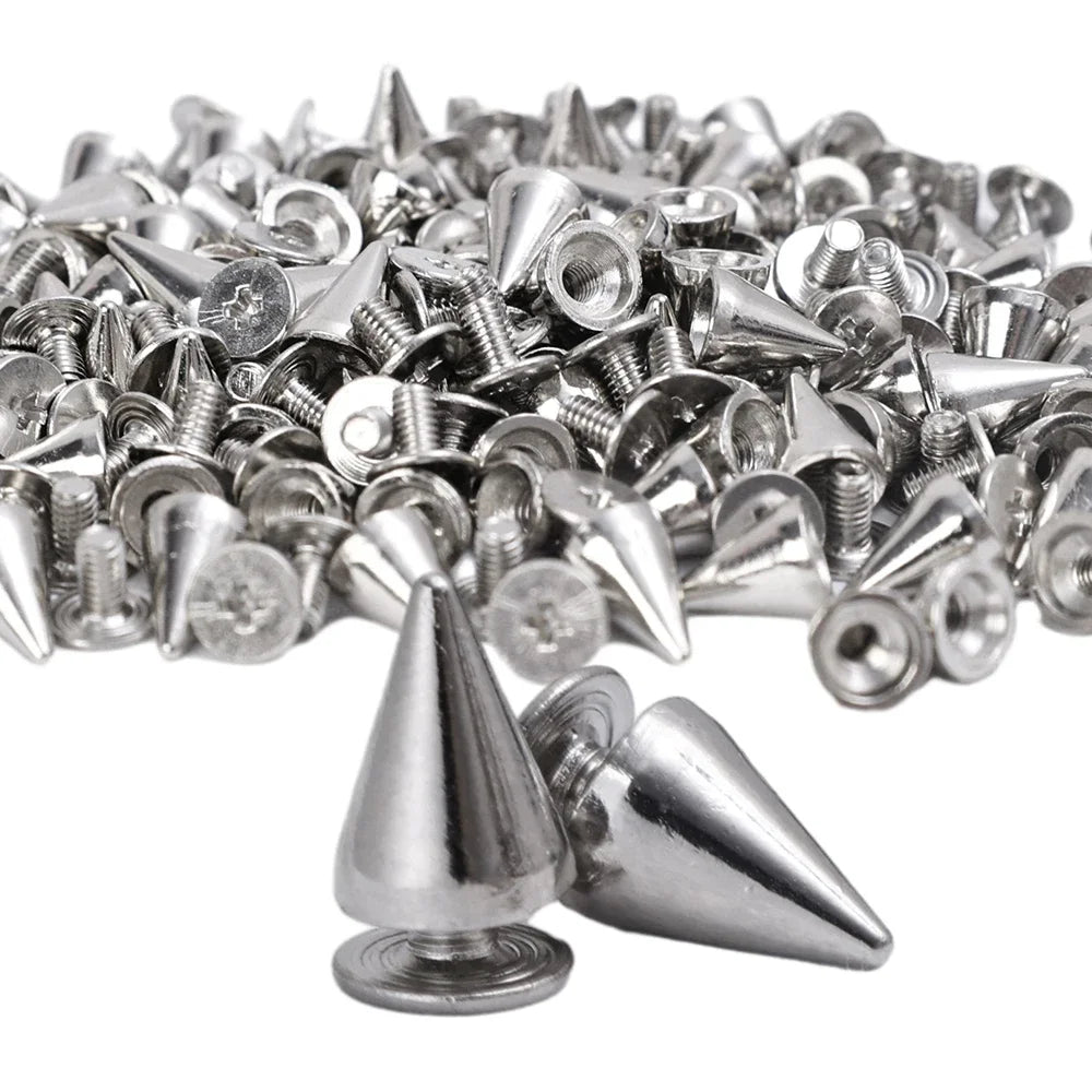 A pile of silver zinc alloy cone studs and spikes used for DIY clothing and accessories.
