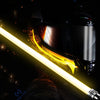 A person holding a yellow lightsaber with bright glow against a dark background.