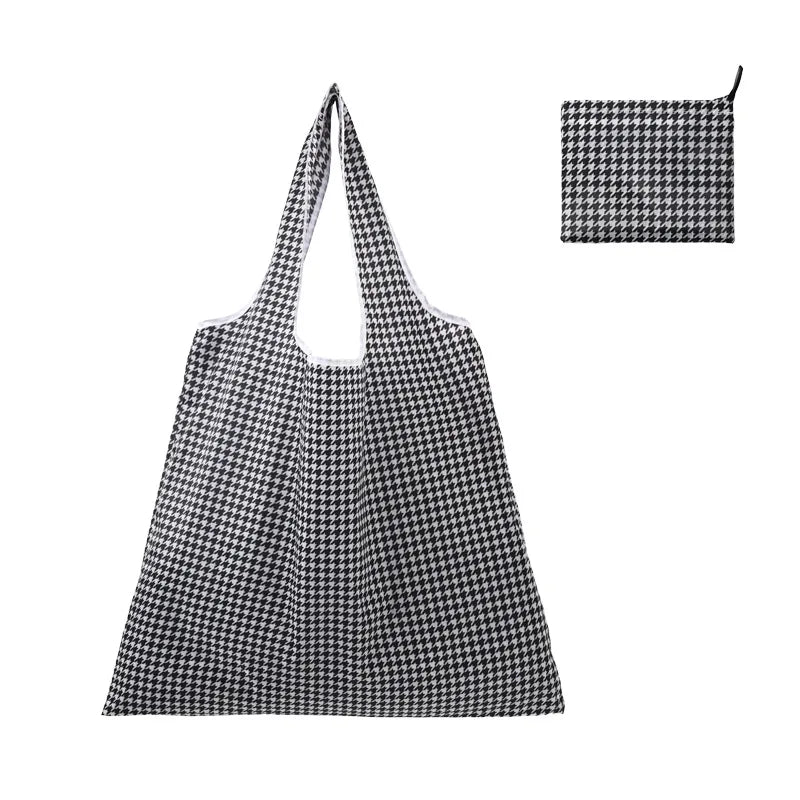 A black and white checkered reusable shopping tote bag with a matching fabric carry pouch.