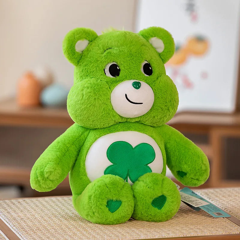 Juguete de peluche Kawaii Care Bears arcoíris verde brillante con parche blanco y cara sonriente.