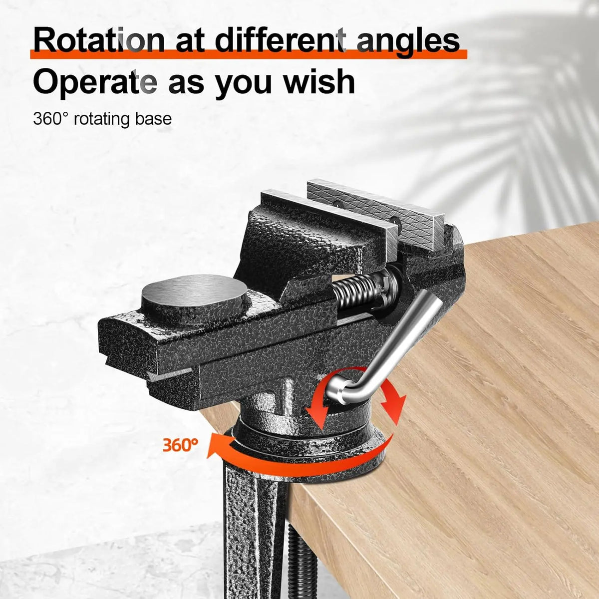 A black swivel clamp-on table vise with a 360 degree rotating base is shown on a wooden surface.