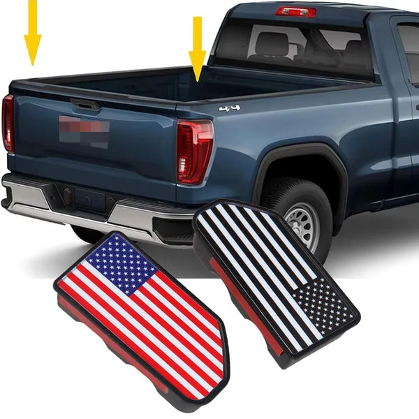 A close-up of truck bed stake pocket covers featuring an American flag and a black and white star pattern.
