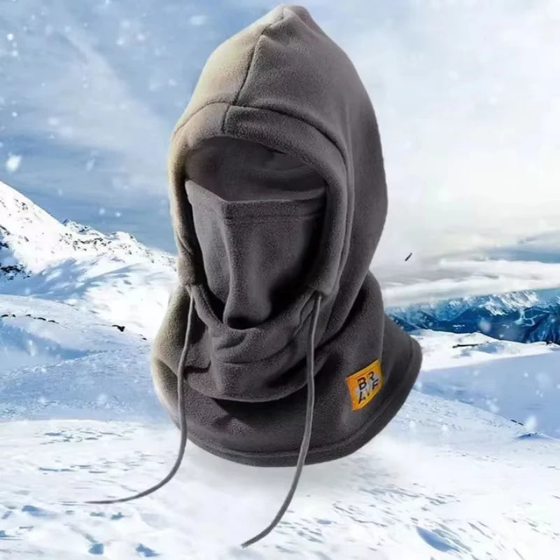 Gray 3-in-1 winter balaclava with mask and neck warmer shown against a snowy mountain background.