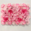 A dense wall panel of pink silk rose flowers for weddings and events.