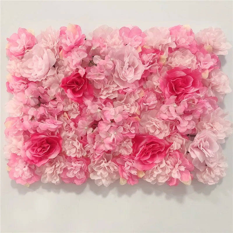 A dense wall panel of pink silk rose flowers for weddings and events.