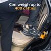 A person's leg wearing black pants and a pair of shoes is shown accessing a vehicle interior with a foldable aluminum car ste