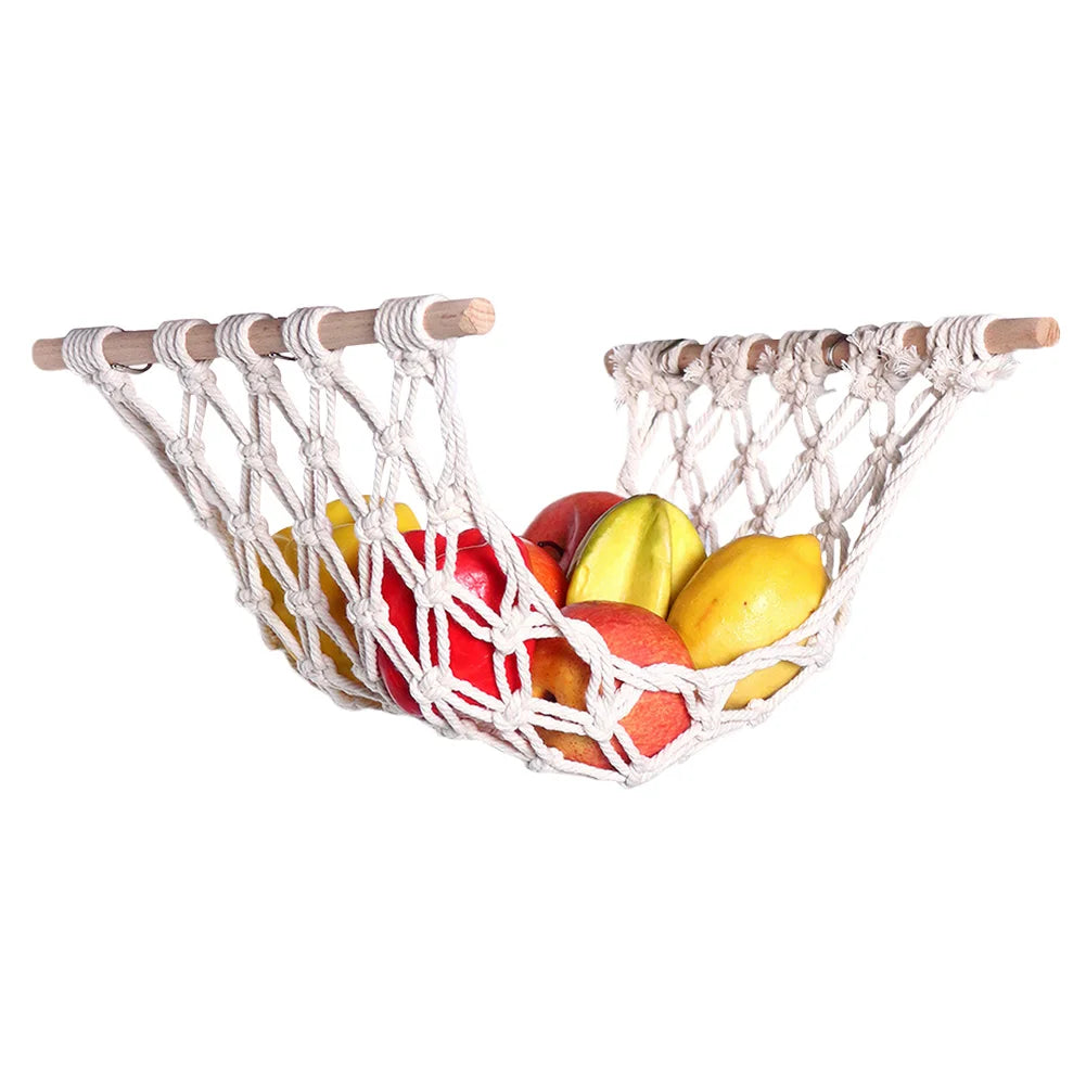 Macrame hanging fruit hammock made of natural fiber holding various colorful fruits.