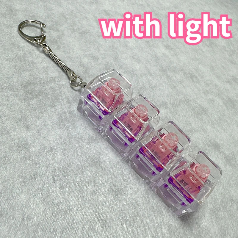 A clear plastic keychain featuring multiple pink LED mechanical fidget toys attached to a silver keyring.