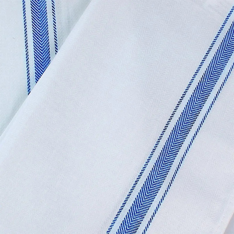 White cotton kitchen towels with blue stripes and piping shown in a close-up view.