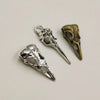 A set of five gothic skull and crow head charms for jewelry making, featuring silver and brass finishes.