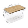 Clear plastic pantry storage bin with a bamboo lid and wooden tray insert.