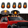 Set of five amber and white LED cab roof marker lights installed on a red truck.