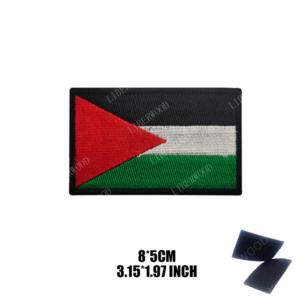 Black embroidered flag patch featuring a red, white, and green triangle design.
