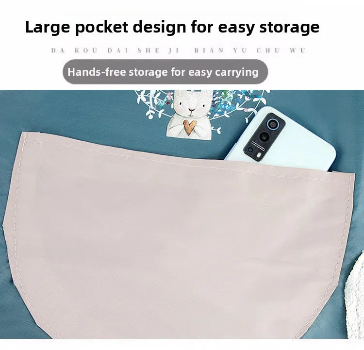 Light pink waterproof kitchen apron shown flat with a smartphone and a small stuffed animal.