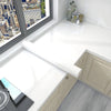 Roll of white marble peel-and-stick wallpaper displayed on a kitchen countertop next to a window view.
