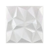A close-up view of a white, geometric 3D diamond wall panel design.
