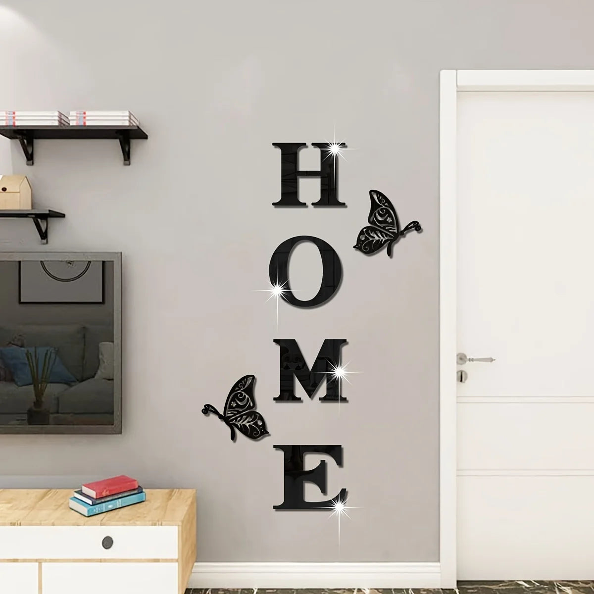 A set of six butterfly-shaped acrylic wall stickers spelling out HOME on a light gray wall.