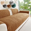 A brown plush sofa cover with a textured pattern is displayed indoors next to a window.