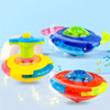 Colorful glowing musical spinning tops in various colors like blue, yellow, and orange are displayed on a light blue backgrou