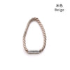 A close-up of a beige rope bracelet with a silver magnetic clasp.