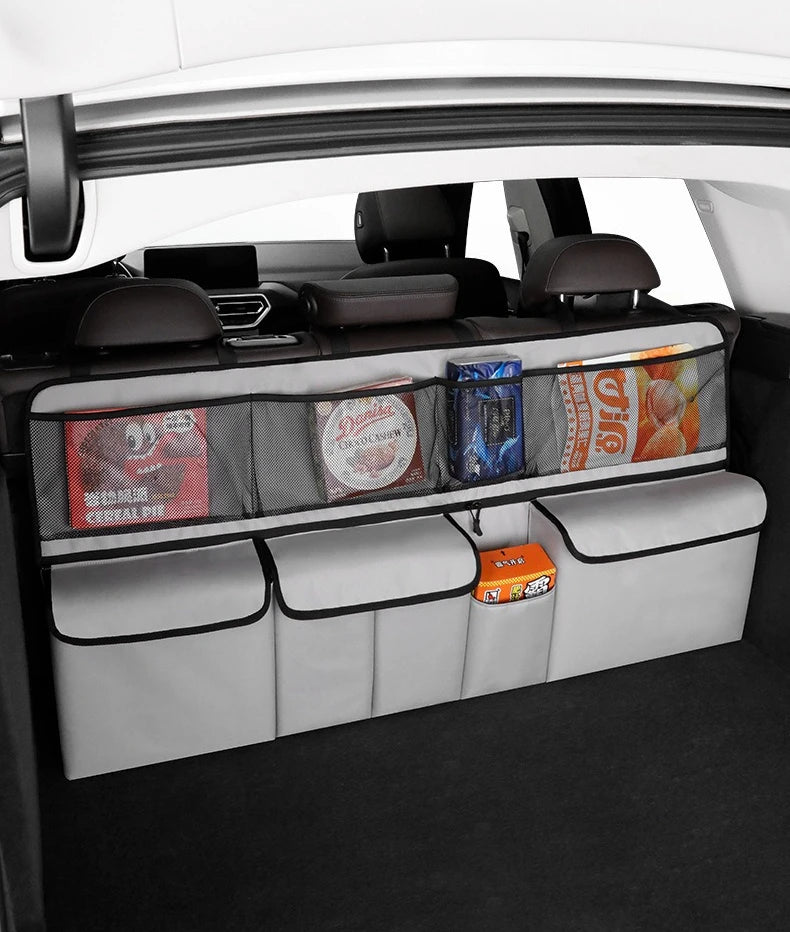 A foldable car trunk organizer with seat back storage is shown inside a car, featuring various storage compartments.