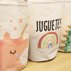 Three white fabric storage baskets featuring colorful cartoon unicorn and rainbow prints.